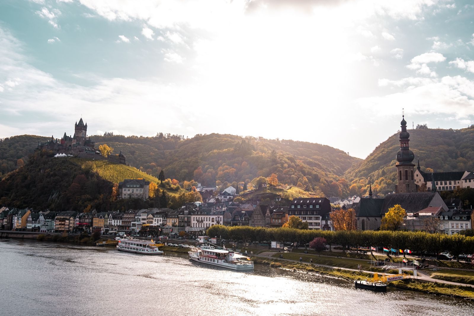 River cruise ships moored at Cochem on the Moselle below the castle, the kind of scene the best river cruise companies sail past
