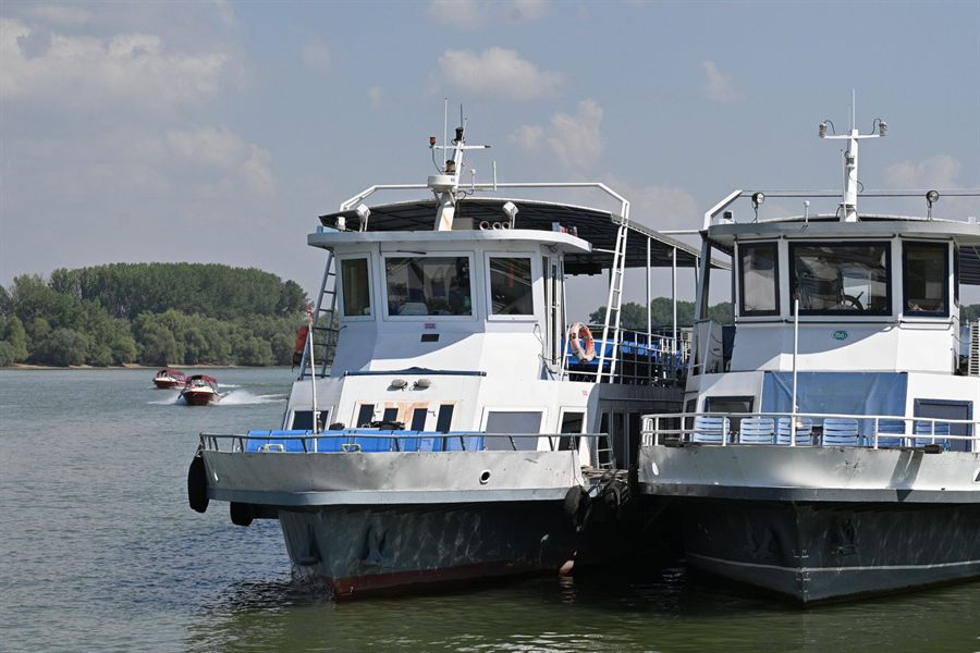 Two passenger ships moored side by side on a river