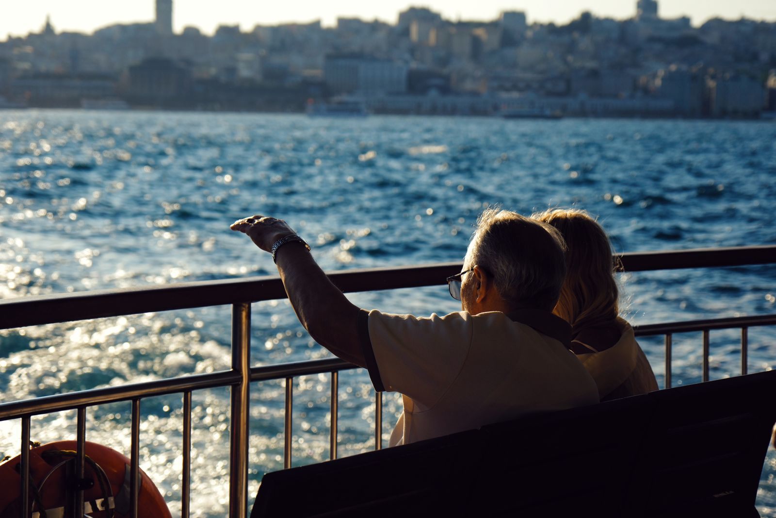 Senior couple enjoying the view from the rail of a boat, the relaxed pace the best river cruise lines for seniors offer